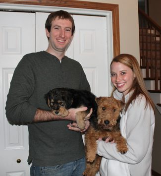 A man and woman holding Charlotte and Merry