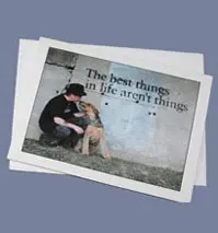 A photo of a person in black attire hugging a dog, near a wall with the phrase "the best things in life aren't things.